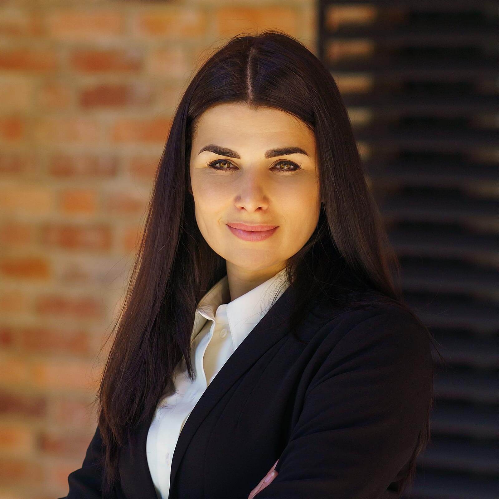 a woman in a business suit posing for a picture