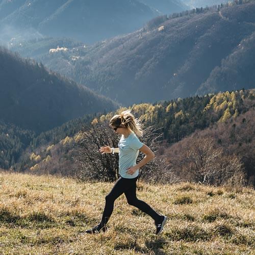 a woman running in the mountains 