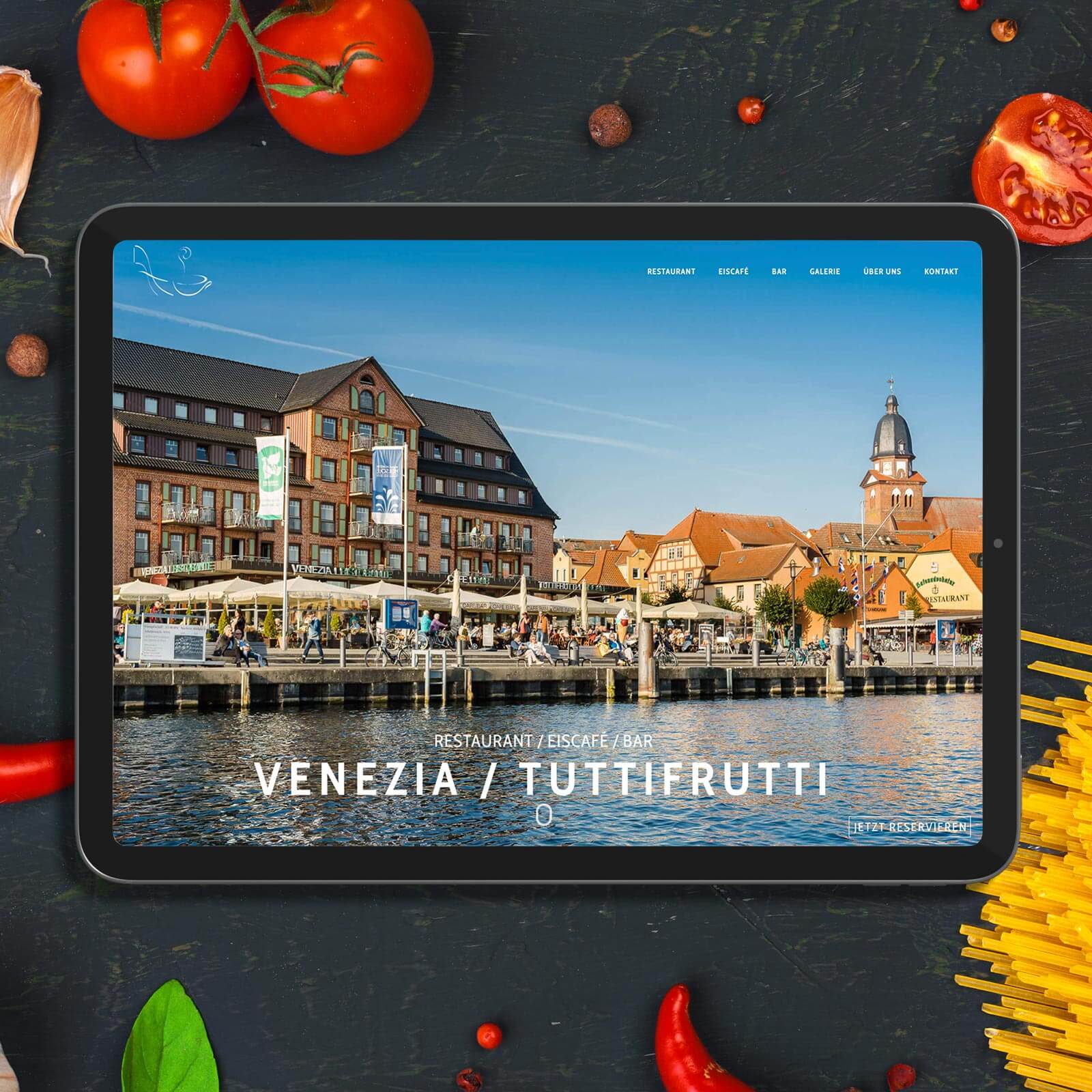 a tablet with a picture of a town on the screen